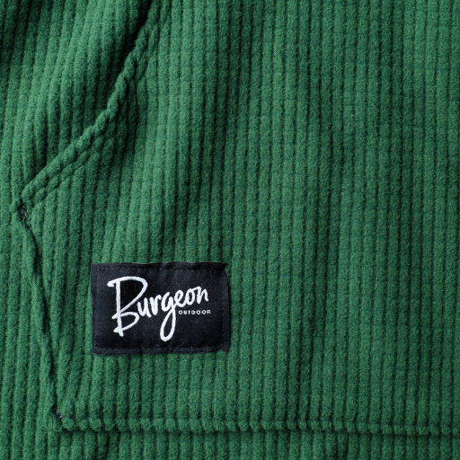 Close-up of a green textured fabric with a 'Burgeon' label.