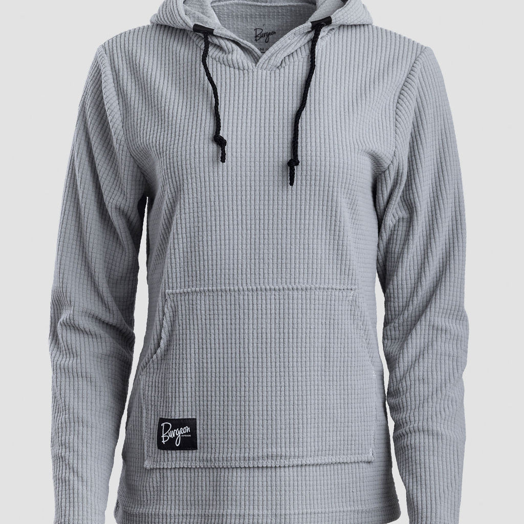 A light gray Highlander Hoodie with black drawstrings and a small black brand patch on the front pocket, shown against a light gray background.