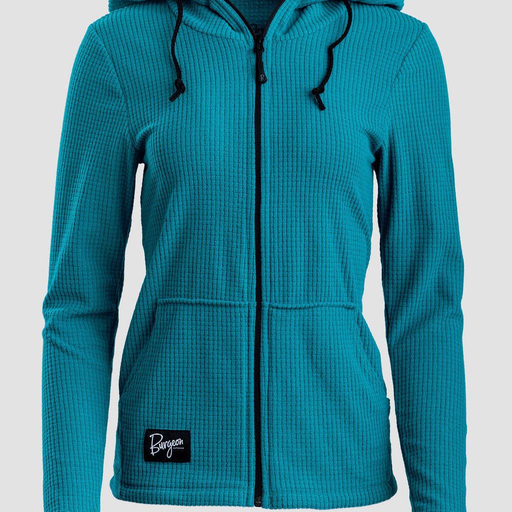 A teal waffle-knit zip-up hoodie with a drawstring hood and front pockets, featuring a small black 'Burgeon' brand patch near the bottom left hem, shown against a light gray background.