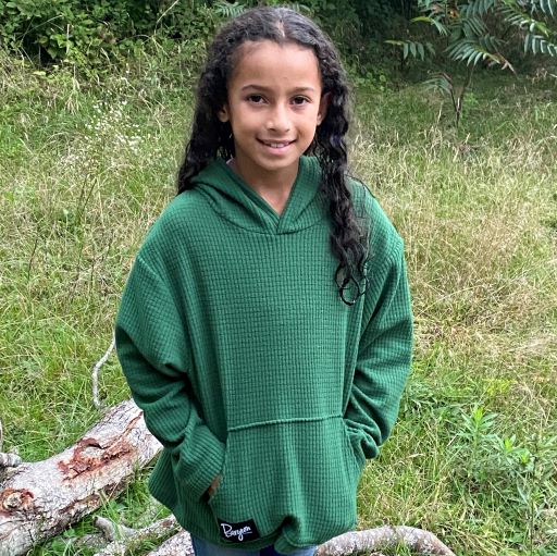 Youth Highlander Hoodie in Green being worn by a child.