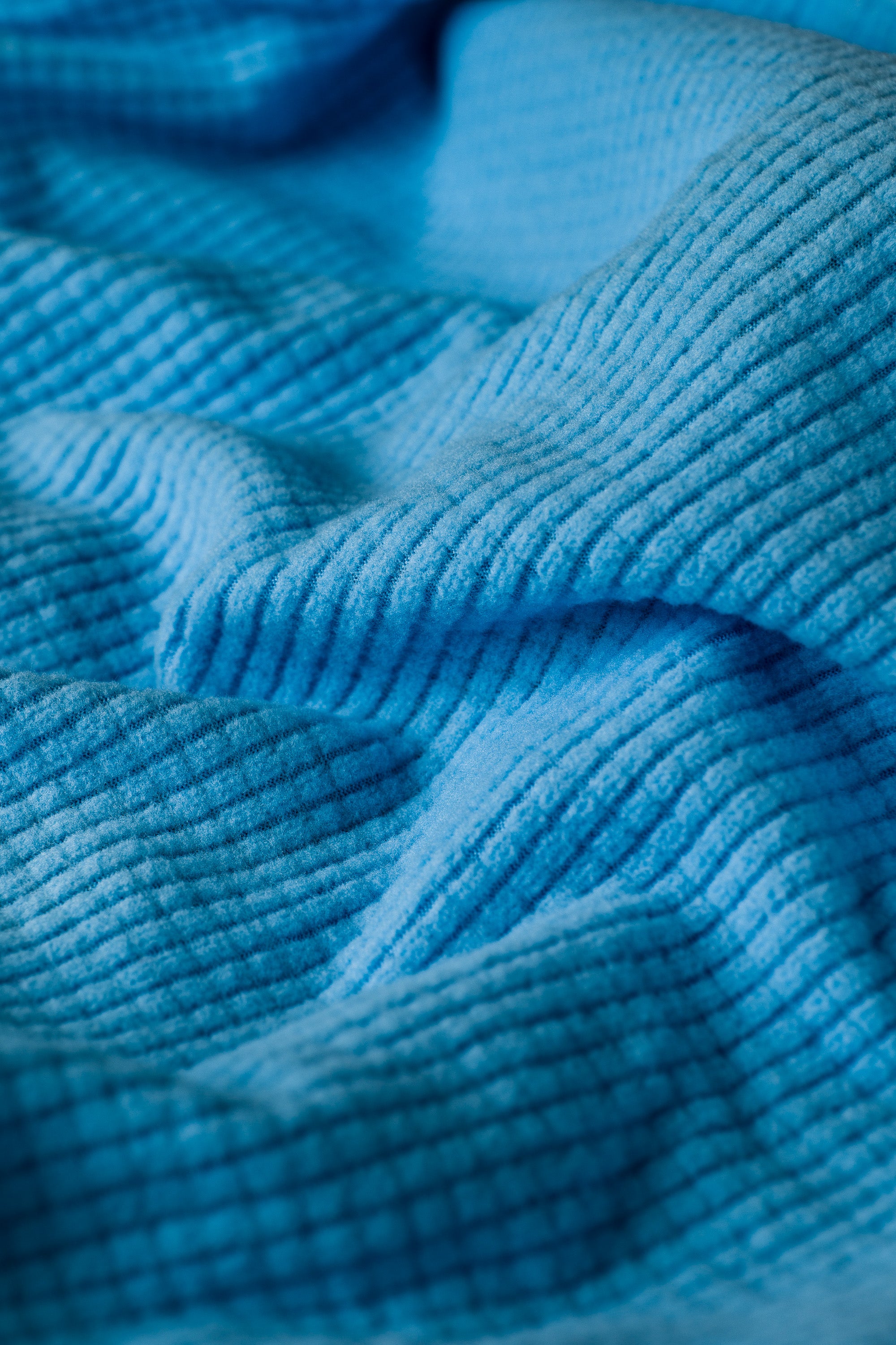 A closeup of a Highlander Hoodie in 'Iceberg.'