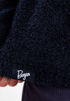 Close-up of a black Alpha 90 hoodie with a small black fabric label reading Burgeon, held by a hand.