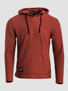 A rust-colored Highlander hoodie with black drawstrings and a small black brand patch on the lower left hem, shown against a light gray background.