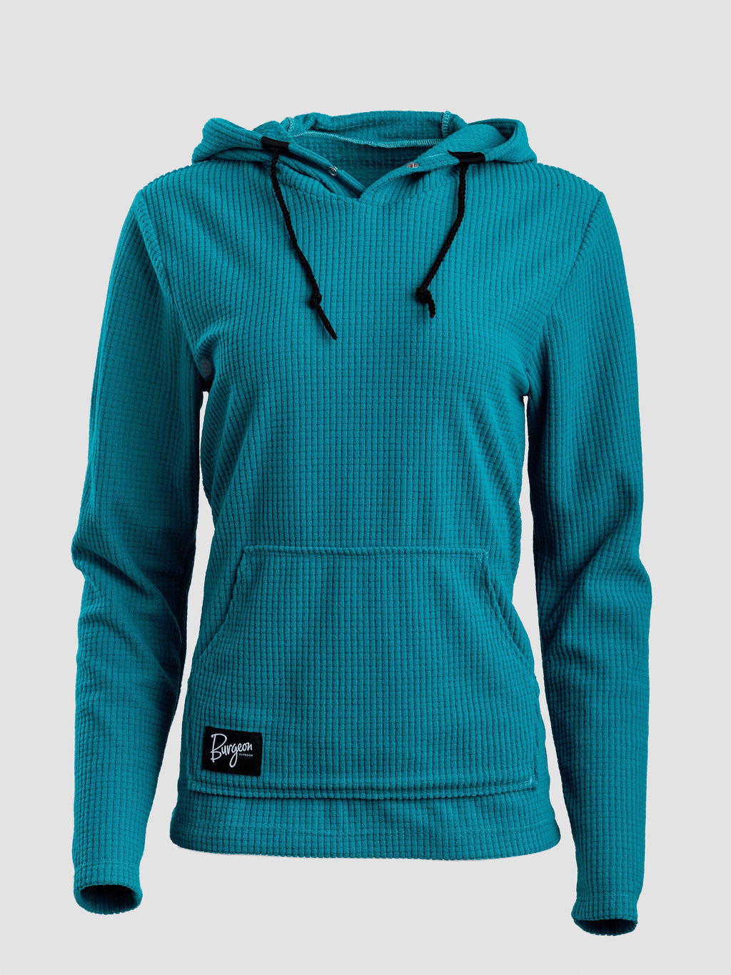 A teal Highlander Hoodie  with black drawstrings and a small black brand patch on the lower left hem, displayed on a neutral light gray background.