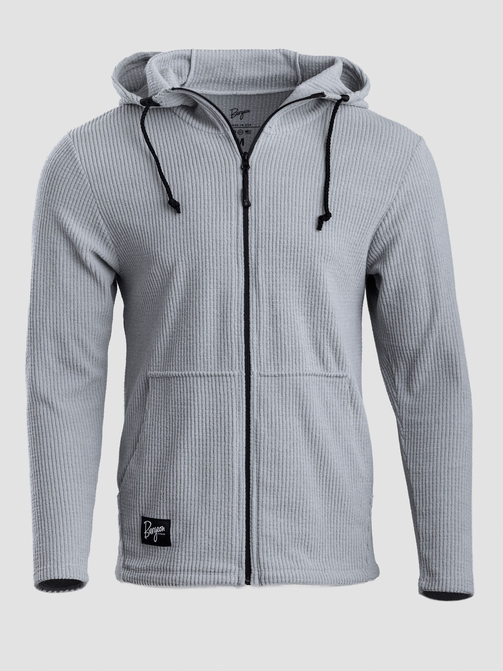 A light gray ribbed zip-up hoodie with black drawstrings and a black zipper, shown on a neutral light gray background.