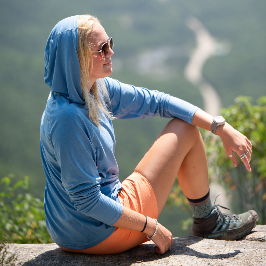 Female Hiker wearing Men's Flume Hoodie in 'Ruddy Duck Blue'