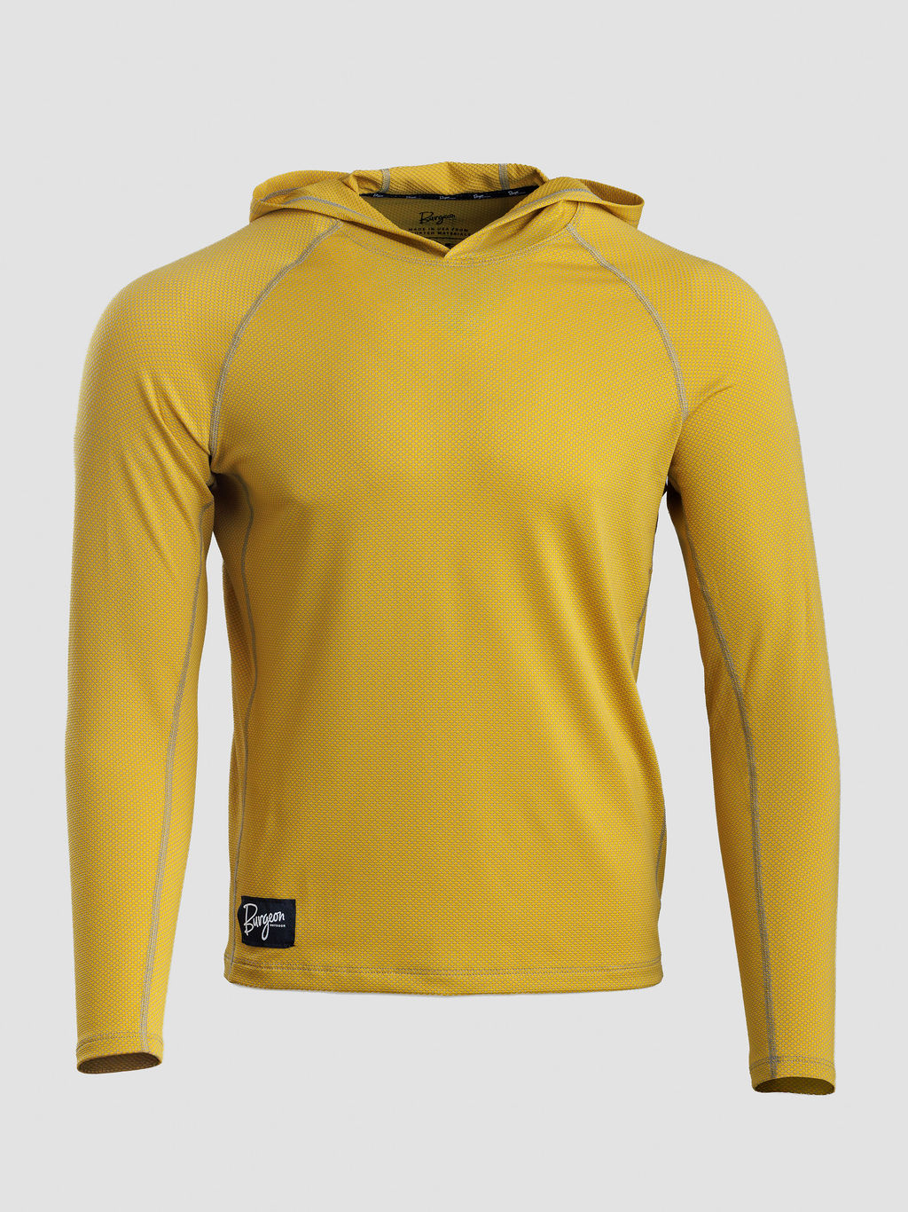 A yellow long-sleeve Sunseeker Hoodie with gray contrast stitching and a small black brand patch near the bottom left hem, shown on a light gray background.
