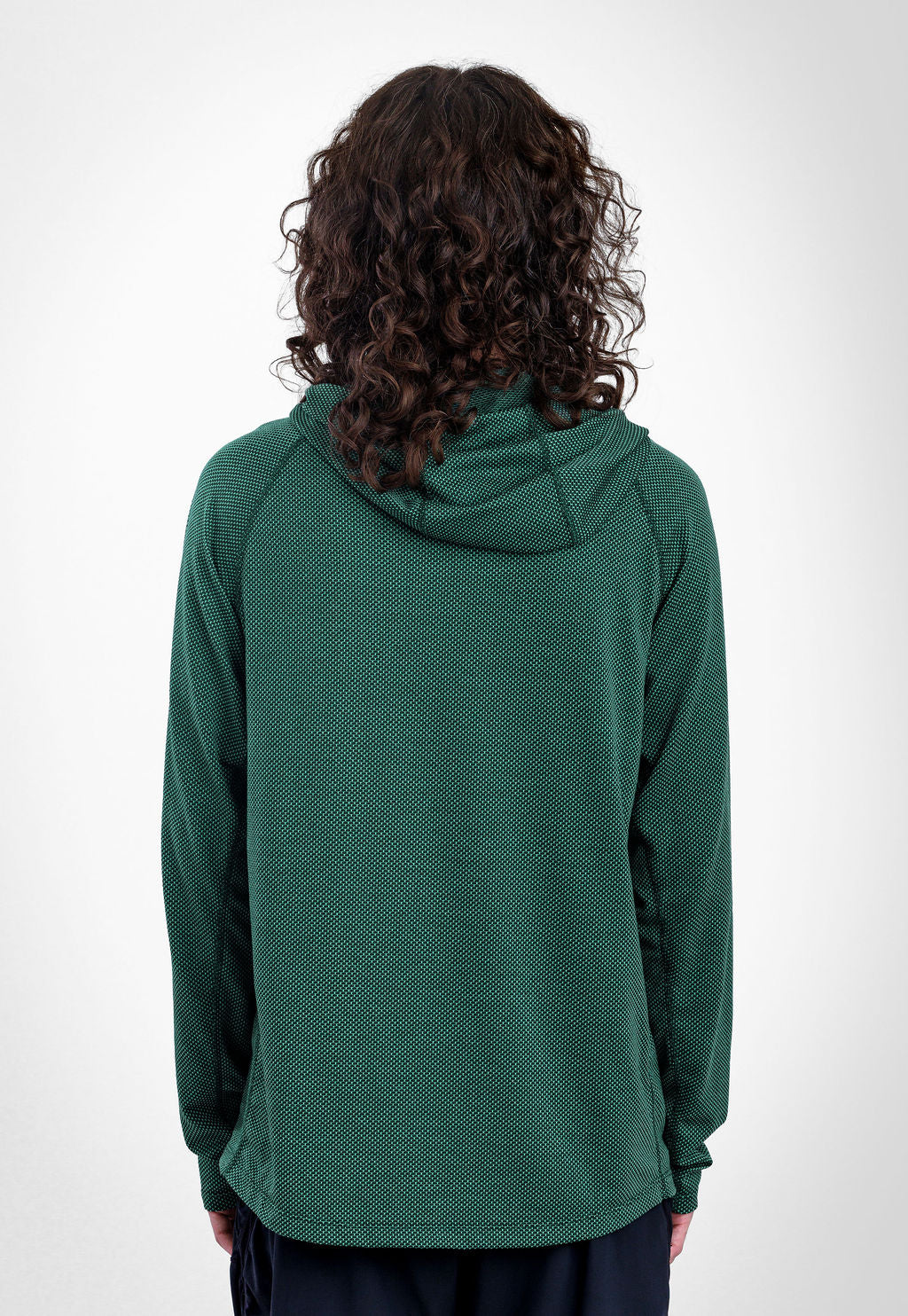 A person viewed from the back wearing a  dark green  long-sleeve Sunseeker Hoodie against a plain light gray studio background.