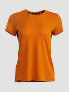 An orange short-sleeve crewneck athletic t-shirt with subtle gray piping details along the shoulders and a small black logo patch near the bottom hem, displayed on a neutral light gray background.