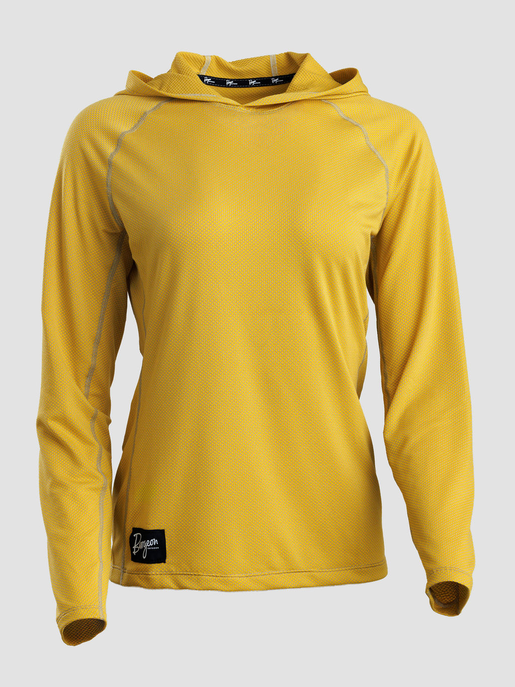 A yellow long-sleeve sun hoodie with a textured mesh fabric, shown on a neutral light gray background. It features a black brand patch near the bottom hem and a black logo strip on the inside of the hood.