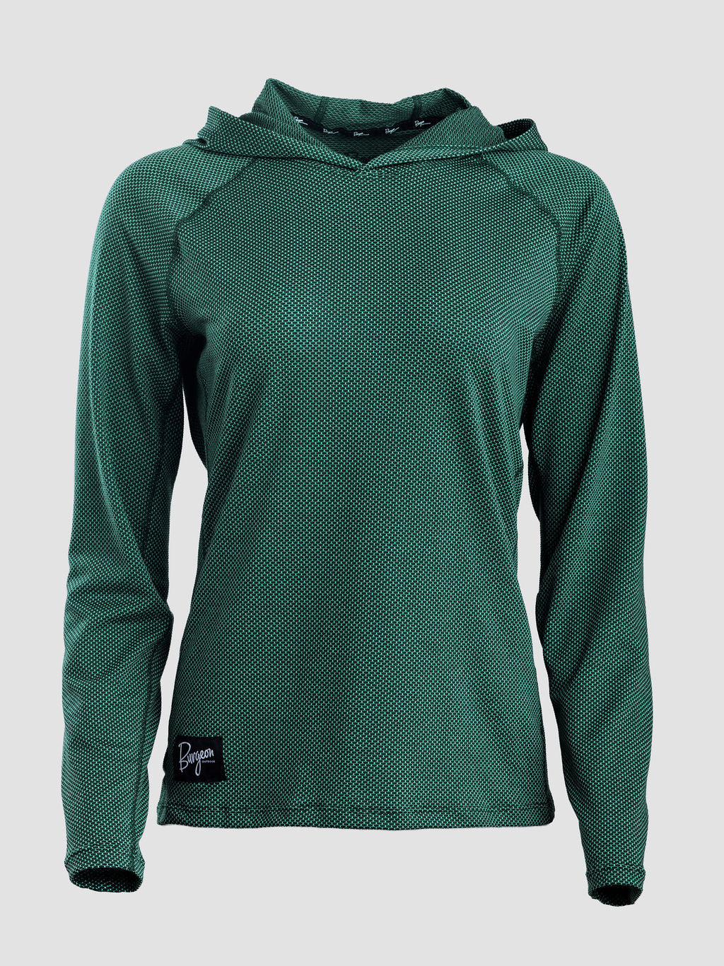 A dark green long-sleeve sun hoodie with a textured, mesh-like fabric, shown on a neutral light gray background. A small black brand patch is visible on the bottom left hem.