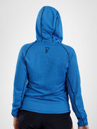A person shown from the back wearing a bright blue long-sleeve sun hoodie with black contrast stitching and a small black monogram logo near the upper back, against a light gray studio background.