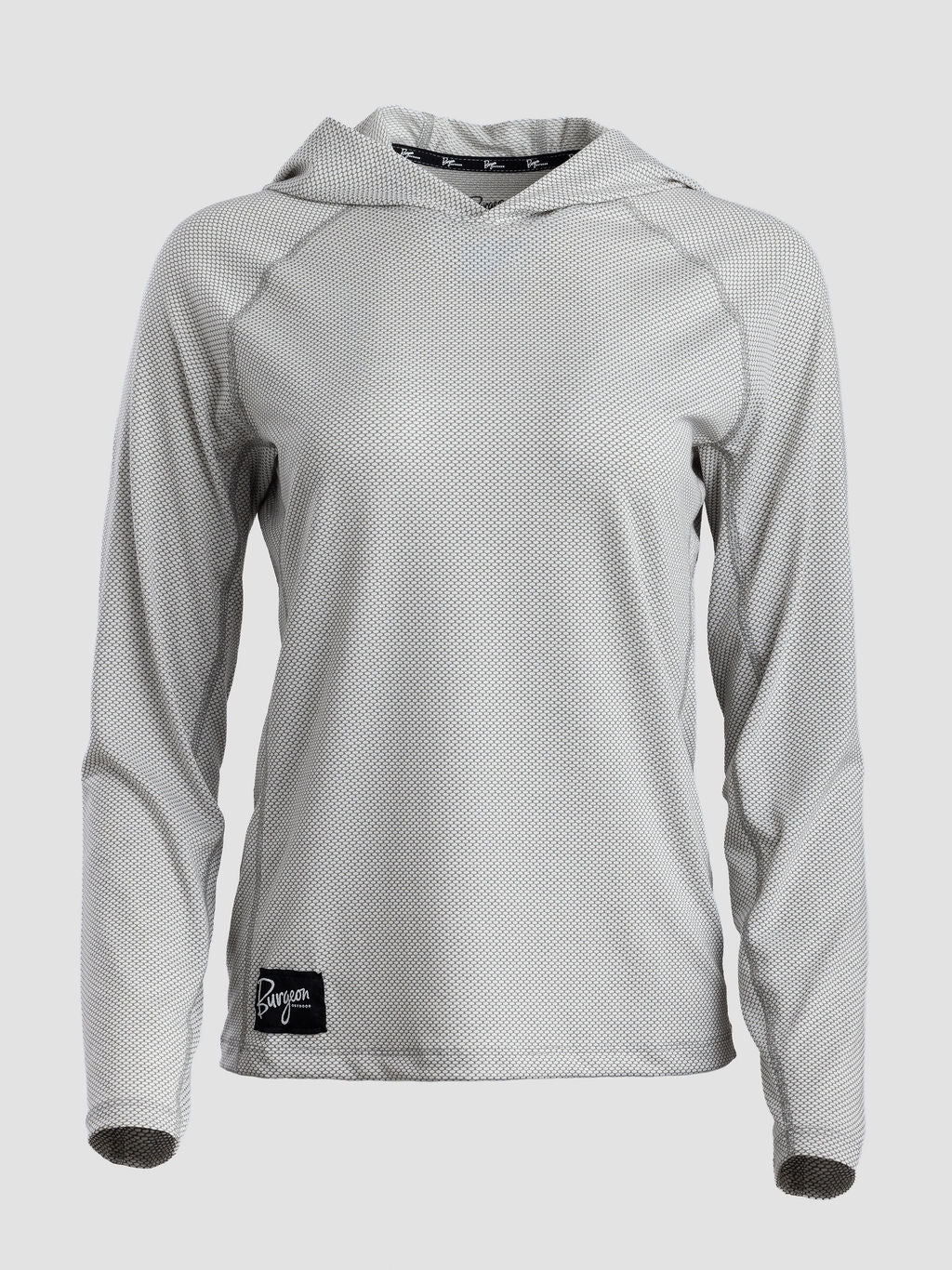 A light gray long-sleeve sun hoodie with a subtle textured pattern, featuring a black brand patch on the lower left hem and a black patterned inner neck label.