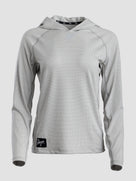 A light gray long-sleeve sun hoodie with a subtle textured pattern, featuring a black brand patch on the lower left hem and a black patterned inner neck label.