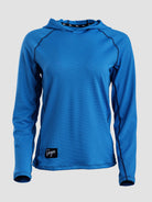 A bright blue long-sleeve sun hoodie with a textured mesh fabric, raglan sleeves, and a small black brand patch near the bottom left hem, shown against a light gray background.
