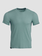 A short-sleeve athletic t-shirt in a muted sage green color, displayed on a neutral light gray background.