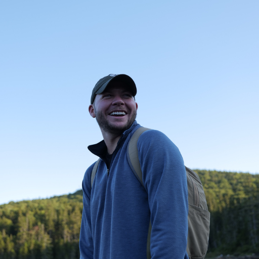 Hiker smiling while wearing the Men's Bond Quarter-Zip in Navy.