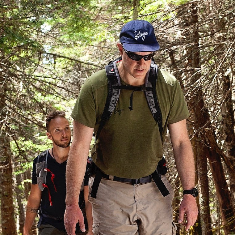 Men's Delta Cool T-Shirt in Olive on a hiker.