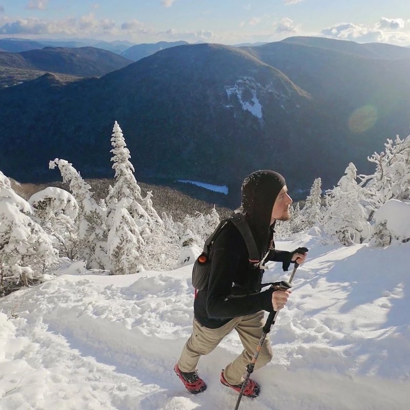 Men's Franconia Jacket in Black worn by a hiker on a snowy mountain. 