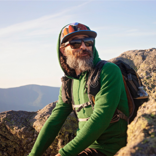 Men's Hiker wearing Green Highlander Hoodie looking into the distance